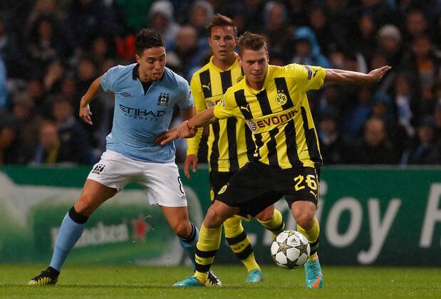 Manchester City s Samir Nasri (L) in action with Borussia Dortmund s Lukasz Piszczek..Champions League football match between Manchester City and Borussia Dortmund at the Etihad Stadium, Manchester on the 3rd October 2012 EDITORIAL USE ONLY. No use with unauthorised audio, video, data, fixture lists, club league logos or live services. Online in-match use limited to 120 images, no video emulation. No use in betting, games or single club league player publications.