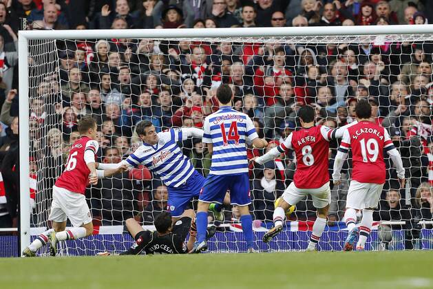 Arsenal s Mikel Arteta scoring his sides opening goal as QPR s Ryan Nelsen attempts to clear..Arsenal FC London v QPR Queens Park Rangers - Barclays Premier League - The Emirates Stadium, London- 27 10 12 - EDITORIAL USE ONLY. No use with unauthorised audio, video, data, fixture lists, club league logos or live services. Online in-match use limited to 120 images, no video emulation. No use in betting, games or single club league player publications.