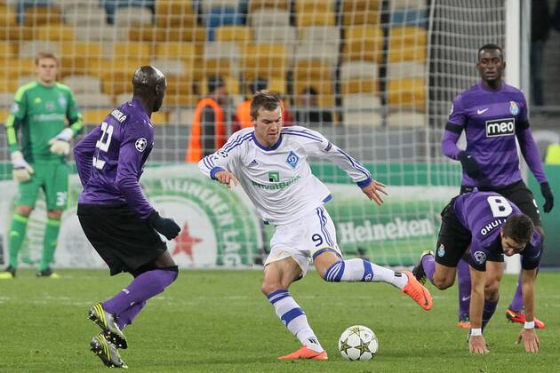 FC Porto defender Eliaquim Mangala and his teammate midfielder Joao Moutinho (violet kit) try to outplay FC Dynamo Kyiv forward Andriy Yarmolenko during the UEFA Champions League Group A match in . 