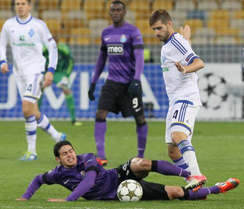 FC Porto forward James Rodriguez (violet kit) tries to slide tackle FC Dynamo Kyiv midfielder Miguel Veloso during the UEFA Champions League Group A match in . 