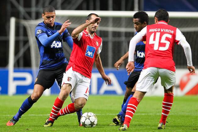 Ruben Micael of SC Braga fights for control among Manchester United defenders during the UEFA Champions League, Group H match, at Estadio Axa in Braga, Portugal.