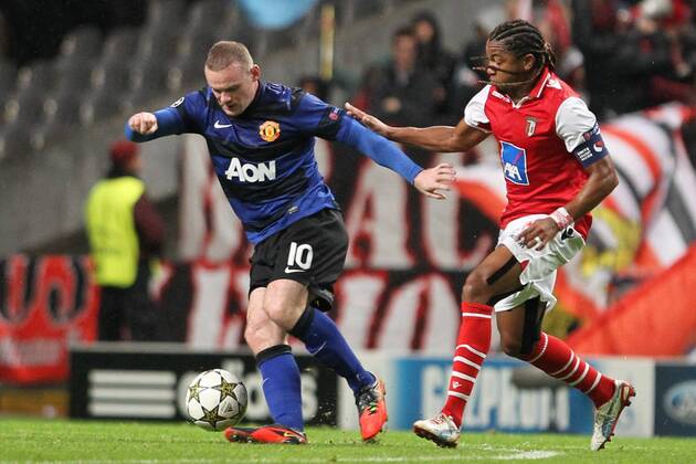 Wayne Rooney (L) of Manchester United challenges Alan of SC Braga during the UEFA Champions League, Group H match, at Estadio Axa in Braga, Portugal.