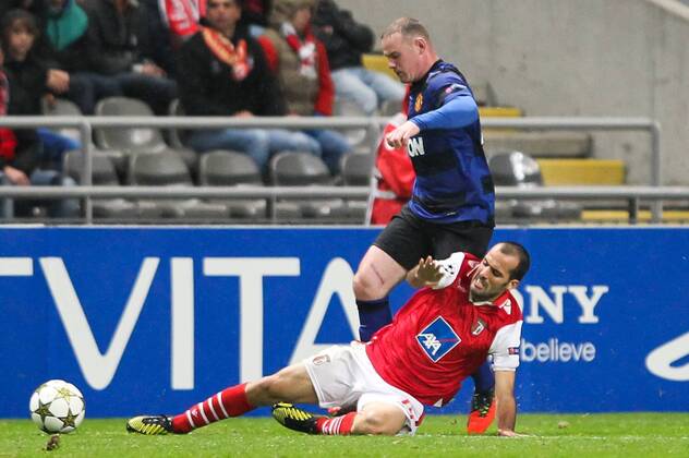 Wayne Rooney of Manchester United challenges Ruben Amorim of SC Braga during the UEFA Champions League, Group H match, at Estadio Axa in Braga, Portugal.