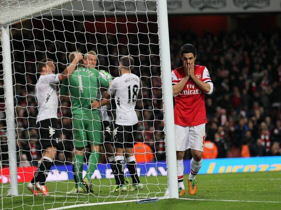 Arsenal s Mikel Arteta looks on dejected after missing a last minute penalty as Fulham s players celebrate..Arsenal FC London v Fulham FC s - Premier League - EDITORIAL USE ONLY. No use with unauthorised audio, video, data, fixture lists, club league logos or live services. Online in-match use limited to 120 images, no video emulation. No use in betting, games or single club league player publications.