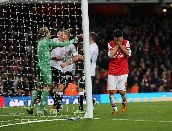 Arsenal s Mikel Arteta looks on dejected after missing a last minute penalty as Fulham s players celebrate..Arsenal FC London v Fulham FC s - Premier League - EDITORIAL USE ONLY. No use with unauthorised audio, video, data, fixture lists, club league logos or live services. Online in-match use limited to 120 images, no video emulation. No use in betting, games or single club league player publications.