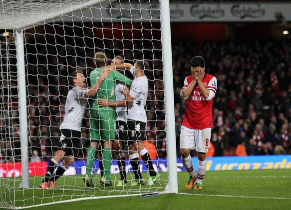 Arsenal s Mikel Arteta looks on dejected after missing a last minute penalty as Fulham s players celebrate..Arsenal FC London v Fulham FC s - Premier League - EDITORIAL USE ONLY. No use with unauthorised audio, video, data, fixture lists, club league logos or live services. Online in-match use limited to 120 images, no video emulation. No use in betting, games or single club league player publications.