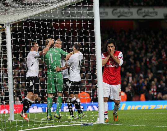 Arsenal s Mikel Arteta looks on dejected after missing a last minute penalty as Fulham s players celebrate..Arsenal FC London v Fulham FC s - Premier League - EDITORIAL USE ONLY. No use with unauthorised audio, video, data, fixture lists, club league logos or live services. Online in-match use limited to 120 images, no video emulation. No use in betting, games or single club league player publications.