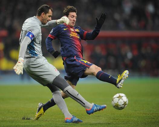 ITAR-TASS: MOSCOW, RUSSIA. NOVEMBER 20, 2012. Spartak s goalkeeper Andrei Dikan (front) and Barcelona s Lionel Messi battle for the ball in a UEFA Champions League Group G football match at Luzhniki Stadium.  RE10DE90
