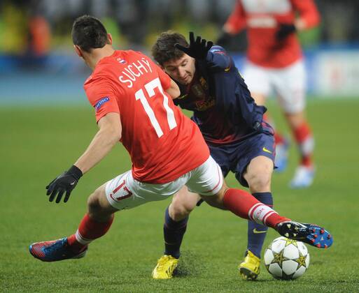ITAR-TASS: MOSCOW, RUSSIA. NOVEMBER 20, 2012. Spartak s Marek Suchy (L) and Barcelona s Lionel Messi fight for the ball in their UEFA Champions Legaue Group G Round 5 football match at Luzhniki Stadium. FC Barcelona won the game 3:0.  premiumd RE10DEC1