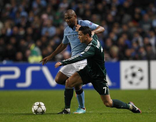 Football - 2012 2013 Champions League - Manchester City vs. Real Madrid Real Madrid s Cristiano Ronaldo battles with Manchester City s Maicon at the Etihad Stadium 