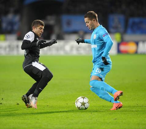 Malaga s Francisco Portillo (L) and Zenit s Viktor Faizulin fight for the ball in their UEFA Champions League Group C Round 5 football match at Petrovsky Stadium. Zenit St. Petersburg vs CF Malaga  RE10E018