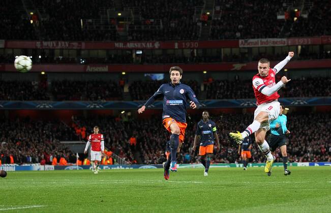 Arsenal s Lukas Podolski scoring his sides second goal. FC Arsenal London v HSC Montpellier -Champions League- Emirates Stadium, London- 21 11 12 - Picture DavidxKlein Sportimage EDITORIAL USE ONLY. No use with unauthorised audio, video, data, fixture lists, club league logos or live services. Online in-match use limited to 120 images, no video emulation. No use in betting, games or single club league player publications.
