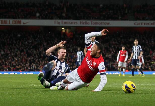 Arsenal s Alex Oxlade-Chamberlain gets fouled for a penalty by WBA s Chris Brunt..Arsenal FC London v West Bromwich Albion - Premier League - Emirates Stadium, London- 8 12 12 - Picture David Klein Sportimage EDITORIAL USE ONLY. No use with unauthorised audio, video, data, fixture lists, club league logos or live services. Online in-match use limited to 120 images, no video emulation. No use in betting, games or single club league player publications.