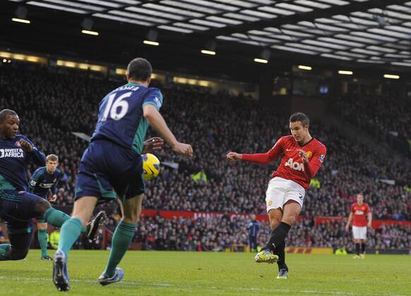 Robin van Persie of Manchester United scores the first - On the left: John Oshea - Barclays Premier League - Manchester United vs AFC Sunderland - Old Trafford Stadium - Manchester - 15 12 12 EDITORIAL USE ONLY. No use with unauthorised audio, video, data, fixture lists, club league logos or live services. Online in-match use limited to 120 images, no video emulation. No use in betting, games or single club league player publications.