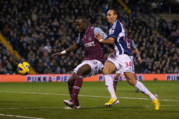 Football - 2012 2013 Premier League - West Bromwich Albion vs. West Ham United West Ham s Guy Demel defends against West Brom s Peter Odemwingie at The Hawthorns