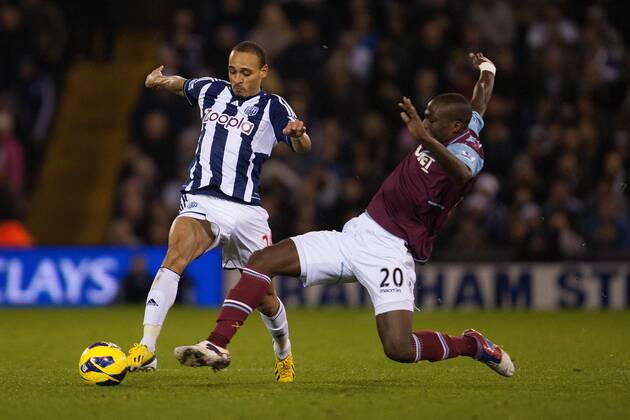 Football - 2012 2013 Premier League - West Bromwich Albion vs. West Ham United West Ham s Guy Demel challenges West Brom s Peter Odemwingie at The Hawthorns