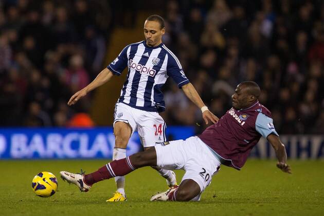 Football - 2012 2013 Premier League - West Bromwich Albion vs. West Ham United West Ham s Guy Demel challenges West Brom s Peter Odemwingie at The Hawthorns