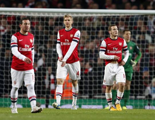 Arsenal s Jack Wilshere looks on dejected after going 2-0 down. On the left Per Mertesacker. FC Arsenal London vs. Manchester City - Barclays Premier League - Emirates Stadium, London- 13 01 13 EDITORIAL USE ONLY. No use with unauthorised audio, video, data, fixture lists, club league logos or live services. Online in-match use limited to 120 images, no video emulation. No use in betting, games or single club league player publications.