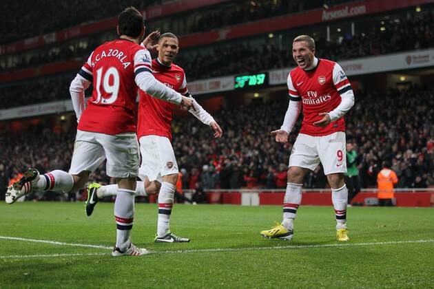 Arsenal s Lukas Podolski celebrates setting up his sides third goal..Arsenal v West Ham United - Barclays Premier League - the Emirates Stadium, London- 23 01 13 - Picture David Klein Sportimage EDITORIAL USE ONLY. No use with unauthorised audio, video, data, fixture lists, club league logos or live services. Online in-match use limited to 120 images, no video emulation. No use in betting, games or single club league player publications.