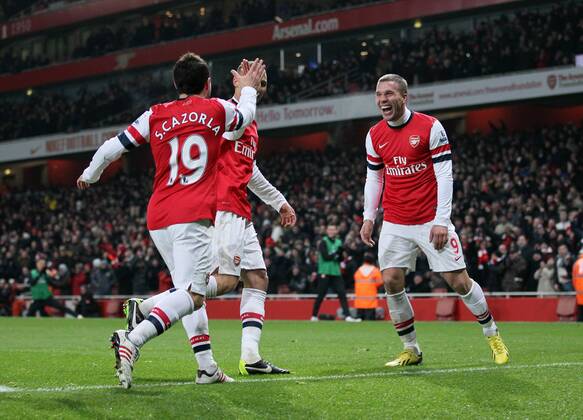 Arsenal s Lukas Podolski celebrates setting up his sides third goal..Arsenal v West Ham United - Barclays Premier League - the Emirates Stadium, London- 23 01 13 - Picture David Klein Sportimage EDITORIAL USE ONLY. No use with unauthorised audio, video, data, fixture lists, club league logos or live services. Online in-match use limited to 120 images, no video emulation. No use in betting, games or single club league player publications.