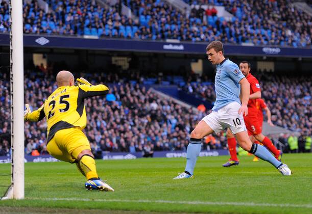 Edin Dzeko of Manchester City scores the first goal past Jose Manuel Reina of Liverpool - Barclays Premier League - Manchester City vs Liverpool - Etihad Stadium - Manchester - 03 02 13 - Picture Simon Bellis Sportimage EDITORIAL USE ONLY. No use with unauthorised audio, video, data, fixture lists, club league logos or live services. Online in-match use limited to 120 images, no video emulation. No use in betting, games or single club league player publications.