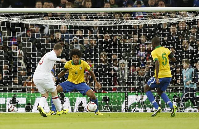 England s Wayne Rooney scoring his sides opening goal..England v Brazil - International Friendly - Wembley Stadium, London- 06 02 13 - Picture David Klein Sportimage EDITORIAL USE ONLY. No use with unauthorised audio, video, data, fixture lists, club league logos or live services. Online in-match use limited to 120 images, no video emulation. No use in betting, games or single club league player publications.