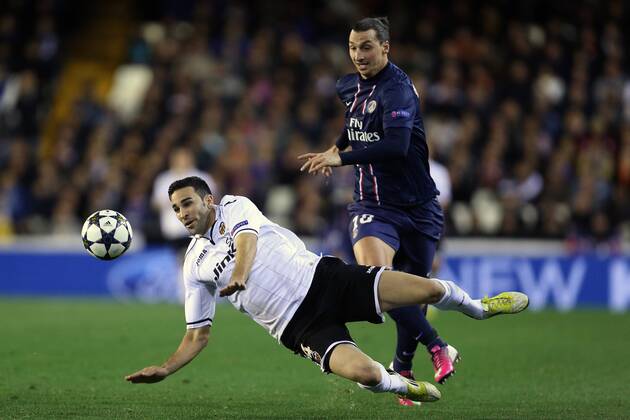Football - 2012 2013 Champions League - Round of 16, First Leg: Valencia CF vs. Paris Saint-Germain (PSG) Zlatan Ibrahimovic of PSG and Valencia s Adil Rami at Mestalla Stadium 