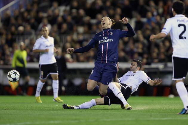 Football - 2012 2013 Champions League - Round of 16, First Leg: Valencia CF vs. Paris Saint-Germain (PSG) Valencia s Adil Rami challenges Zlatan Ibrahimovic of PSG at Mestalla Stadium 