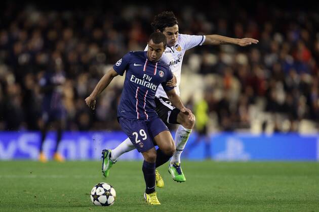 Football - 2012 2013 Champions League - Round of 16, First Leg: Valencia CF vs. Paris Saint-Germain (PSG) Lucas Moura of PSG and Valencia s Tino Costa at Mestalla Stadium 