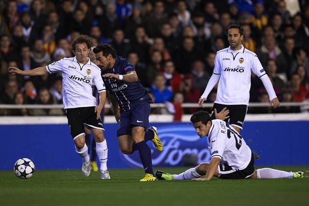 VALENCIA, SPAIN- FEBRUARY 12: (C) Ezequiel Lavezzi of Paris Saint-Germain FC is followed by (L) Andres Guardado of Valencia CF and (R) Ricardo Costa of Valencia CF during UEFA Champions League round of 16 first leg match between Valencia CF and Paris Saint Germain (PSG) at the Mestalla stadium in Valencia, Spain. . 