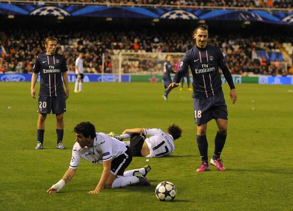 Zlatan Ibrahimovic of Paris Saint Germain (R) leaves two Valencia players on the floor for which he received a red card - UEFA Champions League First Knockout Round 1st leg - FC Valencia vs PSG Paris St Germain - Mestalla Stadium - Valencia - - EDITORIAL USE ONLY. No use with unauthorised audio, video, data, fixture lists, club league logos or live services. Online in-match use limited to 120 images, no video emulation. No use in betting, games or single club league player publications.