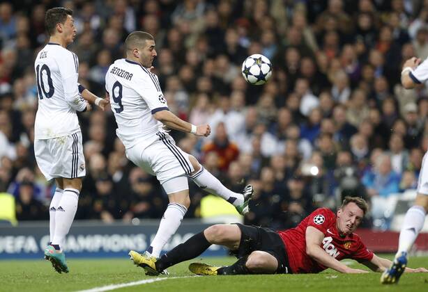 Real Madrid s Mesut Ozil (l) and Karim Benzema (c) and Manchester United s Phil Jones during Champions League 2012 2013 match.February 12,2013.  (20225)