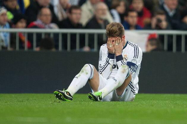 Football - 2012 2013 Champions League - Round of 16, First Leg: Real Madrid vs. Manchester United Sergio Ramos of Real Madrid holds his head in his hands at the Santiago Bernabeu 