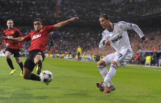 Rafael of Manchester United intercepts Cristiano Ronaldo of Real Madrid - UEFA Champions League First Knockout Round 1st leg - Real Madrid vs Manchester Utd - Bernabau Stadium - Madrid - 13 11 12 - - EDITORIAL USE ONLY. No use with unauthorised audio, video, data, fixture lists, club league logos or live services. Online in-match use limited to 120 images, no video emulation. No use in betting, games or single club league player publications.