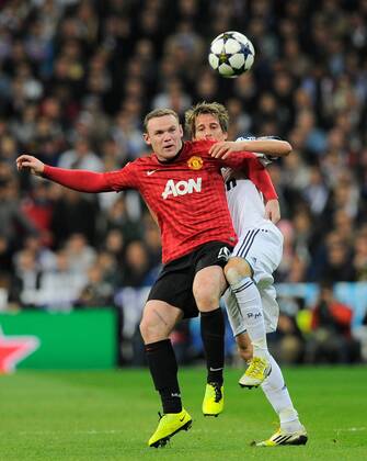Wayne Rooney of Manchester United challenged by Fabio Coentrao of Real Madrid - UEFA Champions League First Knockout Round 1st leg - Real Madrid vs Manchester Utd - Bernabau Stadium - Madrid - 13 11 12 - - EDITORIAL USE ONLY. No use with unauthorised audio, video, data, fixture lists, club league logos or live services. Online in-match use limited to 120 images, no video emulation. No use in betting, games or single club league player publications.