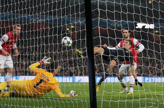 Munich s Thomas Muller scoring his sides second goal..Arsenal v Bayern Munich - Champions League Second Round, First Leg- Emirates Stadium, London- 19 02 13 - Picture David Klein Sportimage EDITORIAL USE ONLY. No use with unauthorised audio, video, data, fixture lists, club league logos or live services. Online in-match use limited to 120 images, no video emulation. No use in betting, games or single club league player publications.