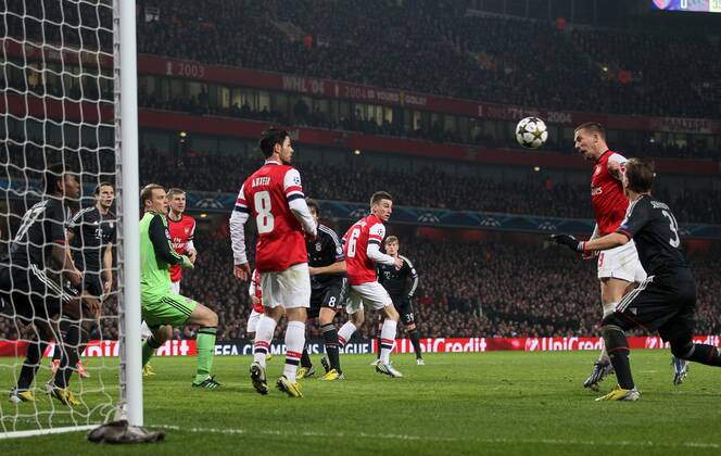 Arsenal s Lukas Podolski scoring his sides opening goal..Arsenal v Bayern Munich - Champions League Second Round, First Leg- Emirates Stadium, London- 19 02 13 - Picture David Klein Sportimage EDITORIAL USE ONLY. No use with unauthorised audio, video, data, fixture lists, club league logos or live services. Online in-match use limited to 120 images, no video emulation. No use in betting, games or single club league player publications.