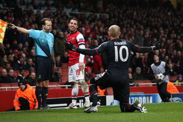 Football - 2012 2013 Champions League - Round of 16, First Leg: Arsenal vs. Bayern Munich Bayern Munich s Arjen Robben jokes with Santi Cazorla of Arsenal at the Emirates Stadium, London