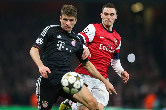 Football - 2012 2013 Champions League - Round of 16, First Leg: Arsenal vs. Bayern Munich Bayern Munich s Thomas Müller and Thomas Vermaelen of Arsenal at the Emirates Stadium, London