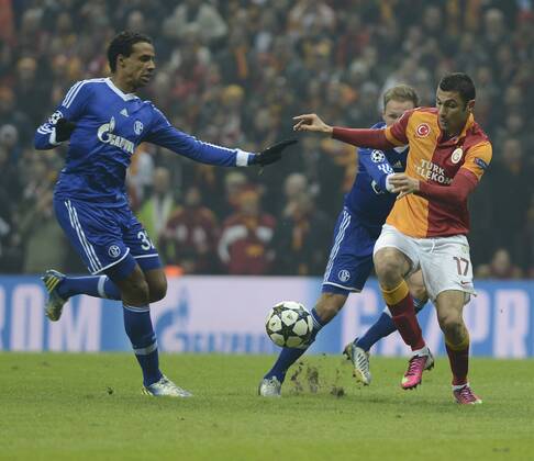 UEFA Champions League last sixteen first leg match between Galatasaray and Schalke 04 at Turk Telekom Arena Stadium in Istanbul on 20.02.2013 Pictured: Burak Yilmaz (L) of Galatasaray and Joel Matip and Benedikt Höwedes of Schalke 04 