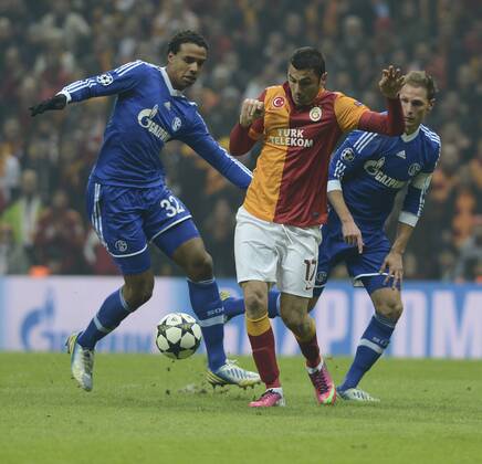 UEFA Champions League last sixteen first leg match between Galatasaray and Schalke 04 at Turk Telekom Arena Stadium in Istanbul on 20.02.2013 Pictured: Burak Yilmaz (L) of Galatasaray and Joel Matip and Benedikt Höwedes of Schalke 04 