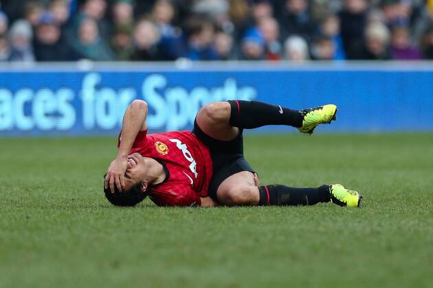 Football - 2012 2013 Premier League - Queens Park Rangers vs. Manchester United (ManU) Manchester United (ManU) s Rafael lies hurt on the floor at Loftus Road, London