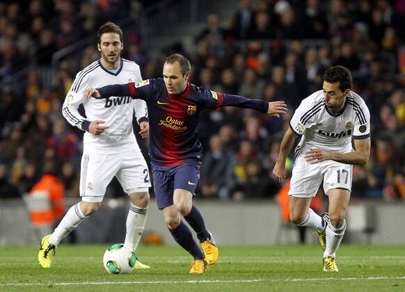 Copa del Rey. FC Barcelona vs Real Madrid. Andres Iniesta with Gonzalo Higuain and Alvaro Arbeloa..
