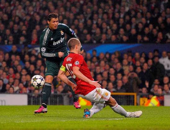 Nemanja Vidic of Manchester United blocks a shot from Cristiano Ronaldo of Real Madrid - UEFA CHAMPIONS LEAGUE - ROUND OF 16 - Manchester Utd vs Real Madrid - Old Trafford Stadium - Manchester - 05 03 13 - Picture Simon Bellis Sportimage- EDITORIAL USE ONLY. No use with unauthorised audio, video, data, fixture lists, club league logos or live services. Online in-match use limited to 120 images, no video emulation. No use in betting, games or single club league player publications.