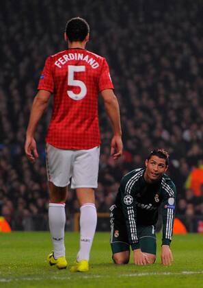 Cristiano Ronaldo of Real Madrid looks up to Rio Ferdinand of Manchester United - UEFA CHAMPIONS LEAGUE - ROUND OF 16 - Manchester Utd vs Real Madrid - Old Trafford Stadium - Manchester - 05 03 13 - Picture Simon Bellis Sportimage- EDITORIAL USE ONLY. No use with unauthorised audio, video, data, fixture lists, club league logos or live services. Online in-match use limited to 120 images, no video emulation. No use in betting, games or single club league player publications.