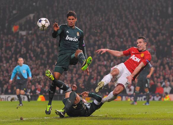 Robin van Persie of Manchester United sees his attempt at a last minute volley blocked by Sergio Ramos of Real Madrid - UEFA CHAMPIONS LEAGUE - ROUND OF 16 - Manchester Utd vs Real Madrid - Old Trafford Stadium - Manchester - 05 03 13 - Picture Simon Bellis Sportimage- EDITORIAL USE ONLY. No use with unauthorised audio, video, data, fixture lists, club league logos or live services. Online in-match use limited to 120 images, no video emulation. No use in betting, games or single club league player publications.