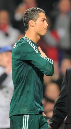 Cristiano Ronaldo of Real Madrid pats his heart as he walks off as the Manchester United fans sing his name - UEFA CHAMPIONS LEAGUE - ROUND OF 16 - Manchester Utd vs Real Madrid - Old Trafford Stadium - Manchester - 05 03 13 - Picture Simon Bellis Sportimage- EDITORIAL USE ONLY. No use with unauthorised audio, video, data, fixture lists, club league logos or live services. Online in-match use limited to 120 images, no video emulation. No use in betting, games or single club league player publications.