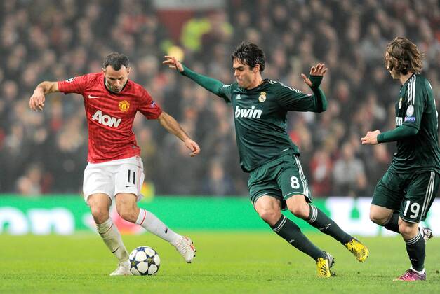 Ryan Giggs of Manchester United holds off Kaka of Real Madrid - UEFA CHAMPIONS LEAGUE - ROUND OF 16 - Manchester Utd vs Real Madrid - Old Trafford Stadium - Manchester - 05 03 13 - Picture Simon Bellis Sportimage- EDITORIAL USE ONLY. No use with unauthorised audio, video, data, fixture lists, club league logos or live services. Online in-match use limited to 120 images, no video emulation. No use in betting, games or single club league player publications.
