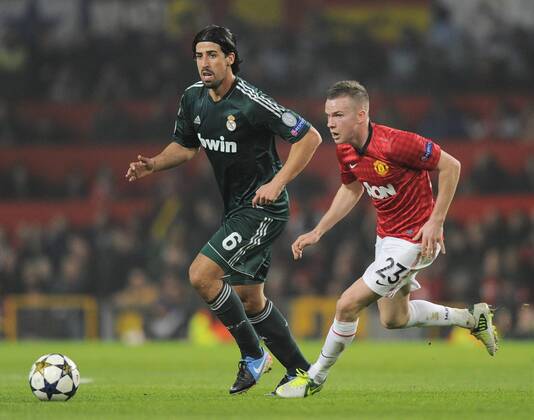 Sami Khedira of Real Madrid and Tom Cleverley of Manchester United - UEFA CHAMPIONS LEAGUE - ROUND OF 16 - Manchester Utd vs Real Madrid - Old Trafford Stadium - Manchester - 05 03 13 - Picture Simon Bellis Sportimage- EDITORIAL USE ONLY. No use with unauthorised audio, video, data, fixture lists, club league logos or live services. Online in-match use limited to 120 images, no video emulation. No use in betting, games or single club league player publications.