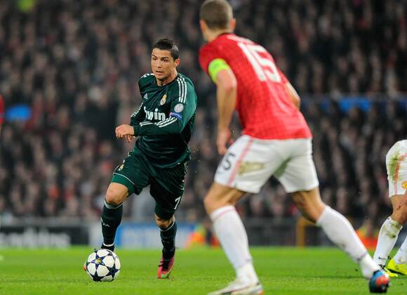 Cristiano Ronaldo of Real Madrid attacks - UEFA CHAMPIONS LEAGUE - ROUND OF 16 - Manchester Utd vs Real Madrid - Old Trafford Stadium - Manchester - 05 03 13 - Picture Simon Bellis Sportimage- EDITORIAL USE ONLY. No use with unauthorised audio, video, data, fixture lists, club league logos or live services. Online in-match use limited to 120 images, no video emulation. No use in betting, games or single club league player publications.
